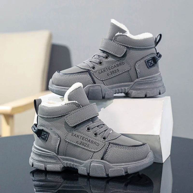 A pair of children's winter velvet warm snow boots with leather waterproof and anti-slip wear-resistant high-top cotton shoes