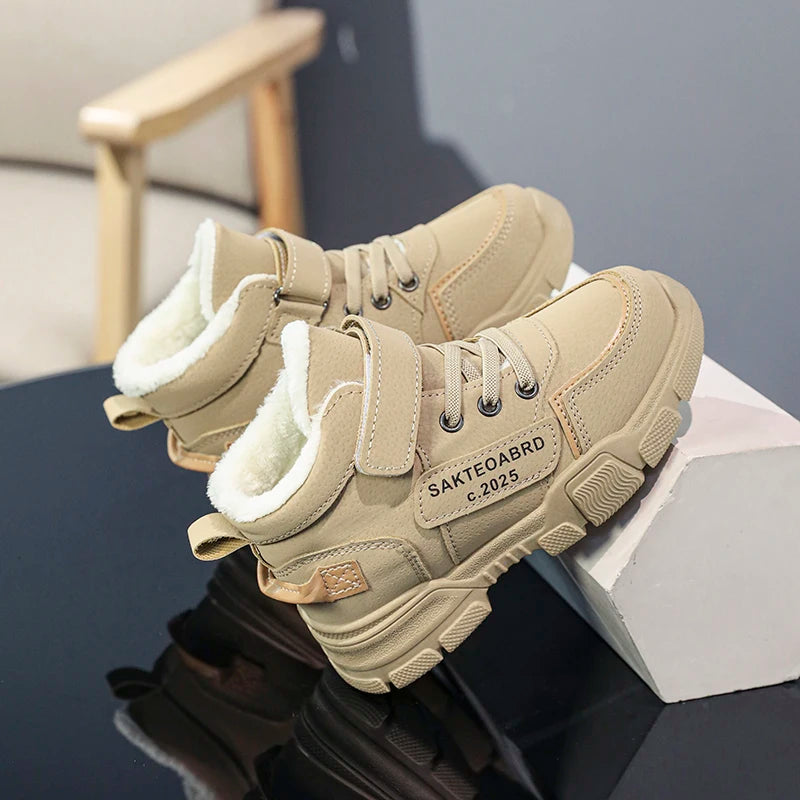 A pair of children's winter velvet warm snow boots with leather waterproof and anti-slip wear-resistant high-top cotton shoes