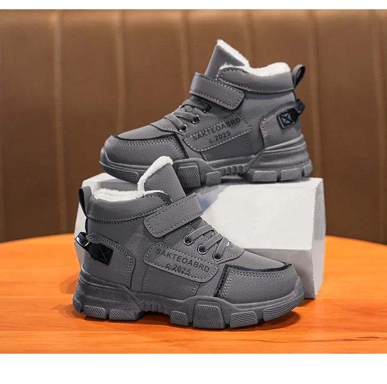 A pair of children's winter velvet warm snow boots with leather waterproof and anti-slip wear-resistant high-top cotton shoes